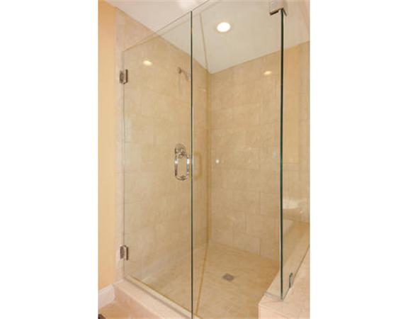 23 Mott Street, Unit 1 Arlington, MA 02474 - Photo 24 of 28 a bathroom with a shower and a glass door