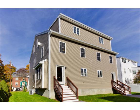 23 Mott Street, Unit 1 Arlington, MA 02474 - Photo 27 of 28 a front view of a house with a yard