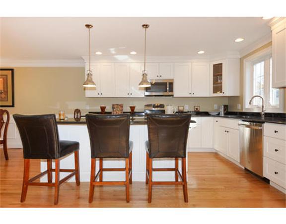 23 Mott Street, Unit 1 Arlington, MA 02474 - Photo 3 of 28 a kitchen with a table chairs sink and cabinets