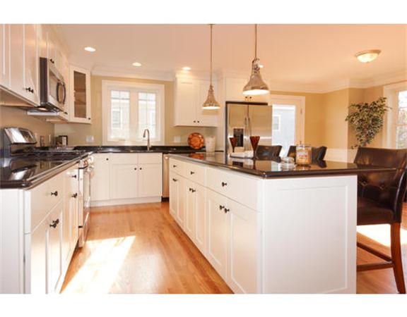 23 Mott Street, Unit 1 Arlington, MA 02474 - Photo 5 of 28 a kitchen with granite countertop a sink cabinets and window