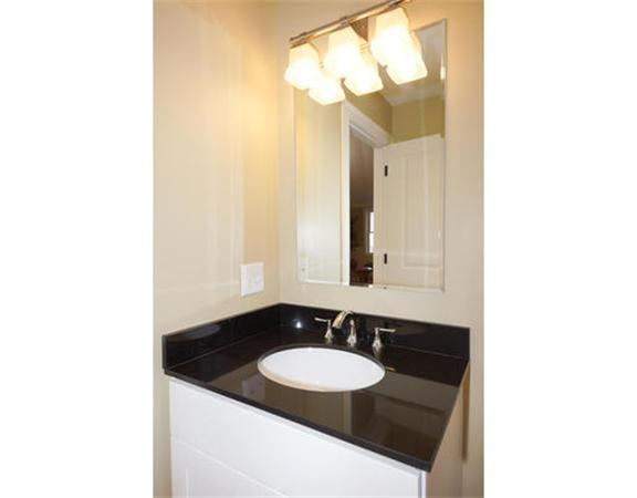 23 Mott Street, Unit 1 Arlington, MA 02474 - Photo 10 of 28 a bathroom with a sink and a mirror