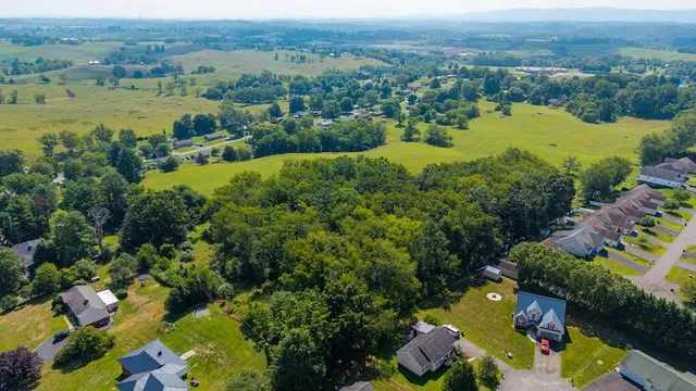 an aerial view of lake residential houses with outdoor space and swimming pool