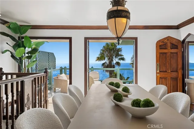 a living room with furniture a chandelier and a potted plant