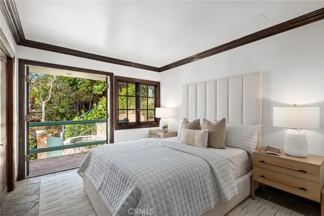 a bedroom with a large bed and a large window