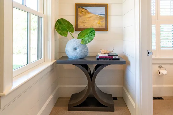 a bathroom with a window and mirror