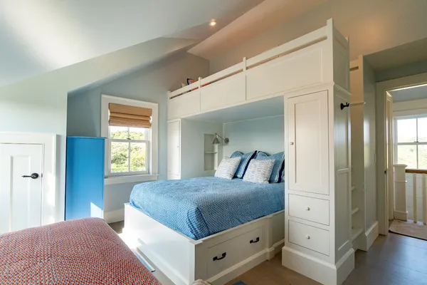 a bedroom with a large bed and a window