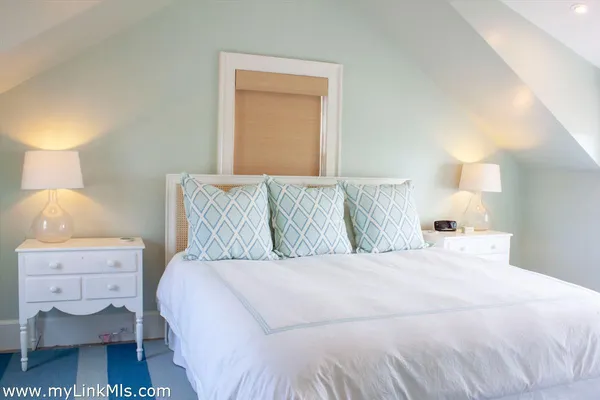 a bedroom with a bed and a night stand