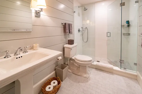 a bathroom with a sink toilet and shower
