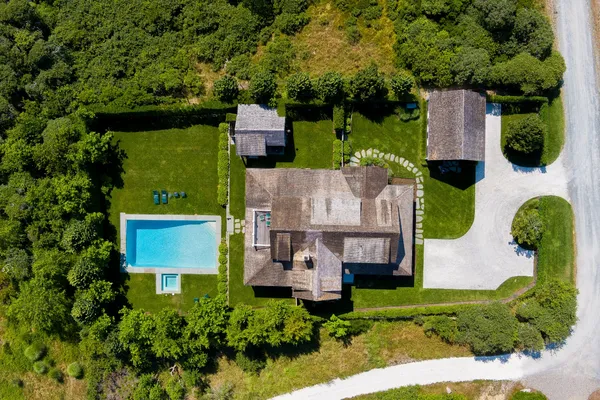 an aerial view of a house with garden space and street view