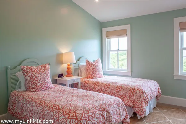 a bedroom with two beds and a window