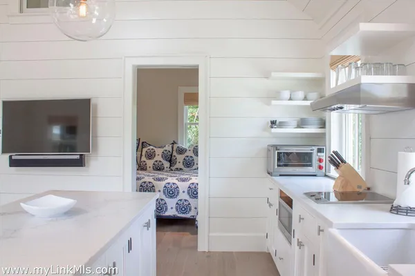 a kitchen with a sink and a stove top oven