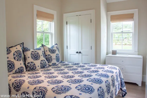 a bedroom with a large bed and a window