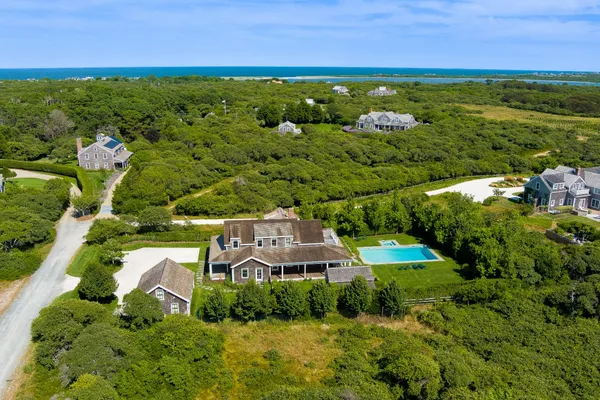 an aerial view of a house with a yard