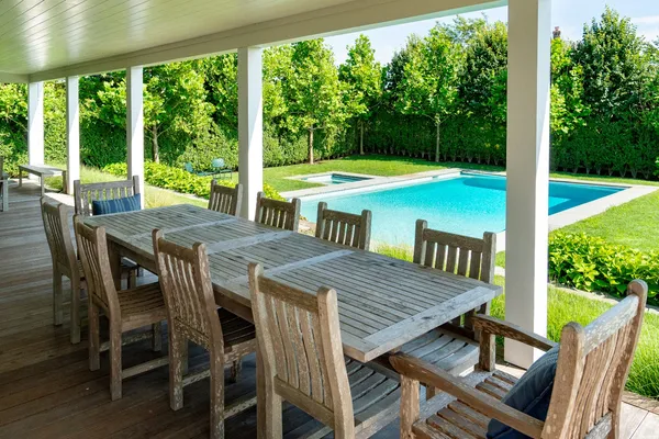a view of a dining table and chairs in the patio