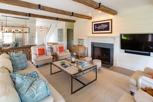 a living room with furniture a flat screen tv and a fireplace