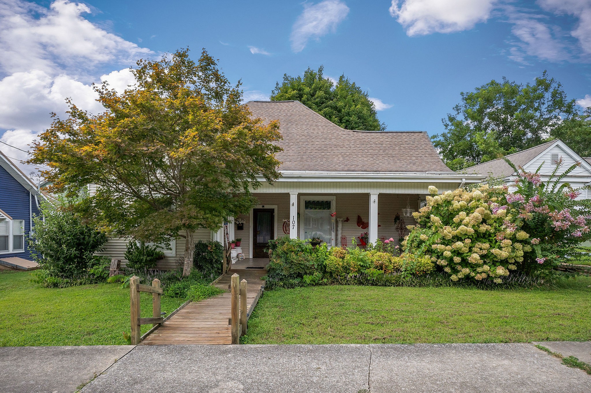 a front view of a house with a garden