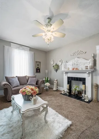a living room with furniture a fireplace and a chandelier