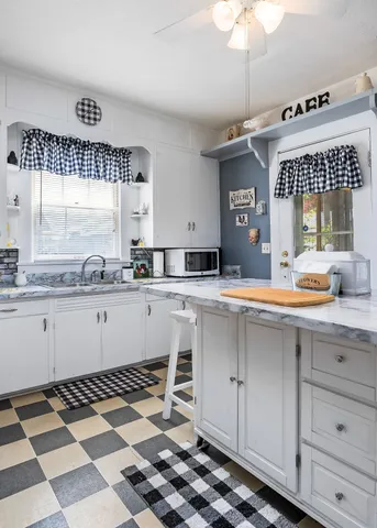 a kitchen with sink cabinets and window