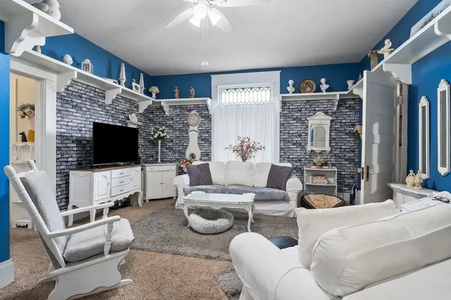 a bedroom with a bed and ceiling fan