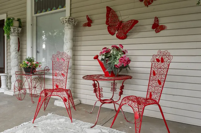 a living room with furniture chandelier and wooden floor