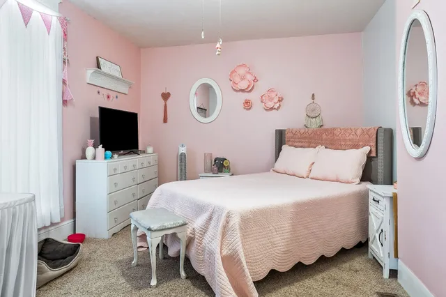 a view of a dining room with furniture and a chandelier