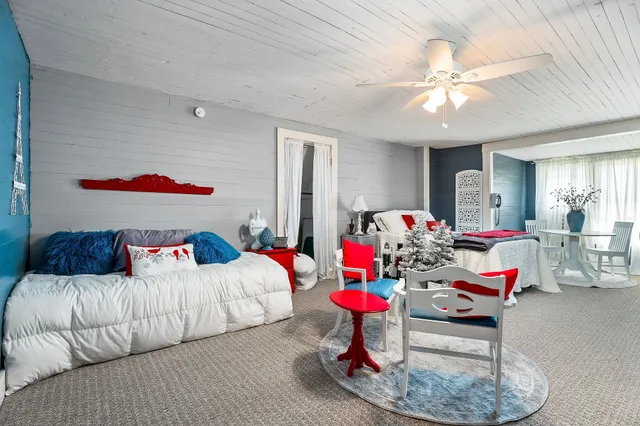 a view of backyard with a large window and wooden floor