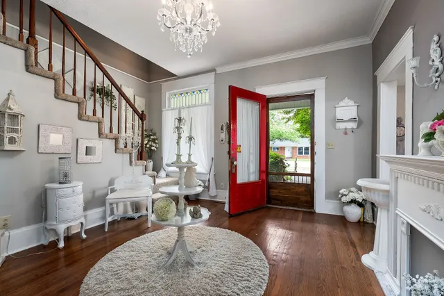 a living room with fireplace furniture and a large window
