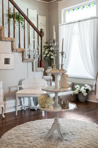 a living room with furniture a clock and a window