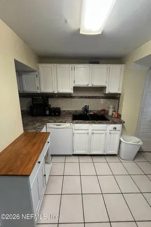 a living room with a couch and a potted plant
