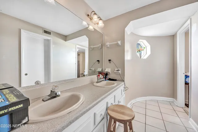 a kitchen with white cabinets and appliances