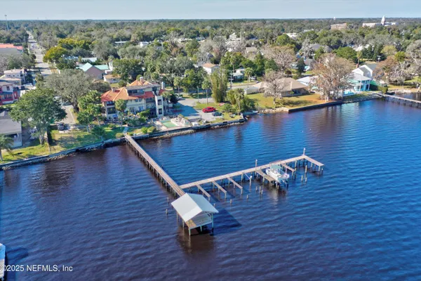 a view of a building with a garden and pathway