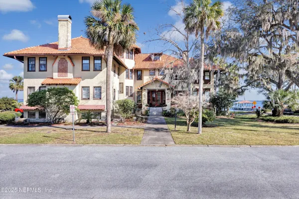 a view of a house with palm trees