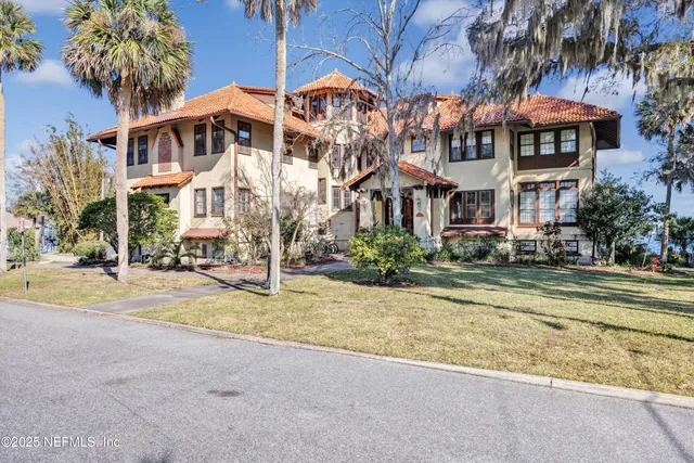a view of a house with palm trees