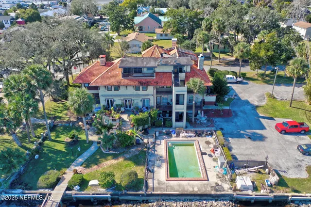 a view of swimming pool with outdoor seating and yard in the back