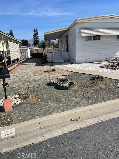 1560 Massachusetts Avenue, Unit 123 Riverside, CA 92507 - Photo 2 of 15 a front view of a house with a yard