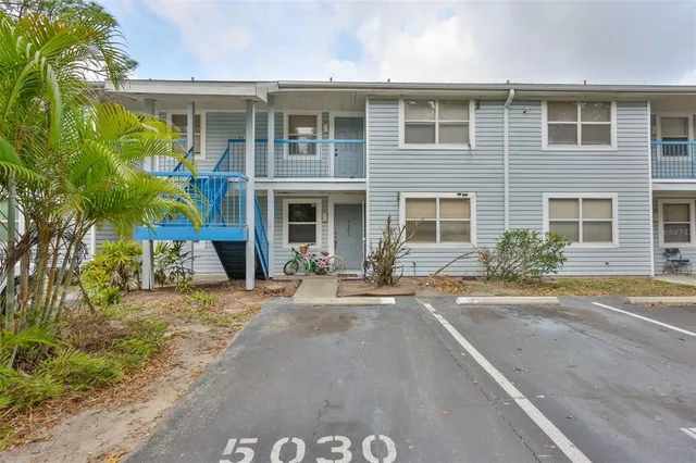 a front view of a house with a yard and a garage