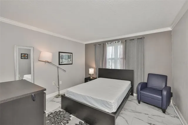 a bedroom with a bed a couch and a window