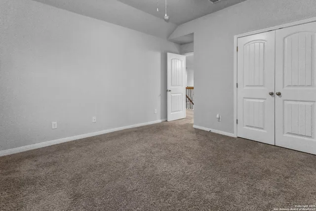 a view of an empty room and closet area