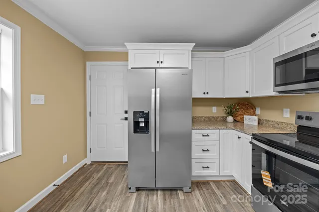 a kitchen with stainless steel appliances a refrigerator and a stove top oven