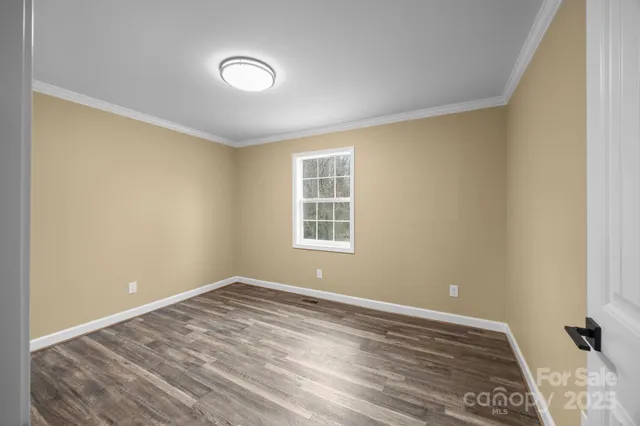 a view of a room with wooden floor and natural light