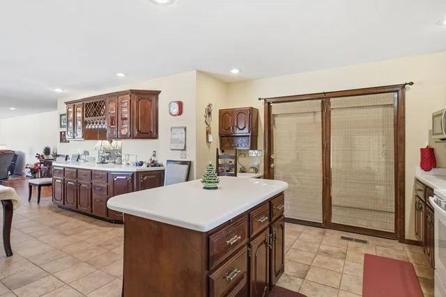 a kitchen with a sink refrigerator and cabinets