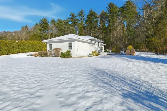 a view of a house with a yard and tree