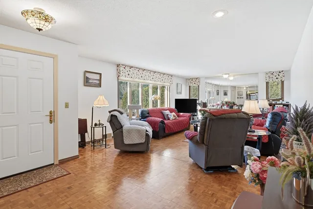 a living room with furniture chess board and a window