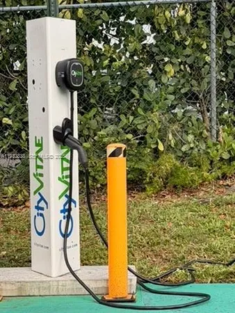 a street sign on a wall next to road