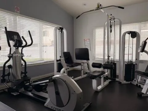 a view of a livingroom with workspace and windows