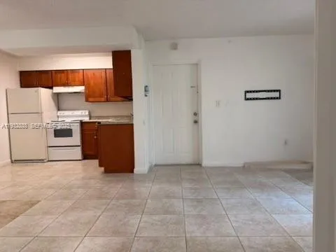 a view of kitchen with stainless steel appliances cabinets and empty shelves