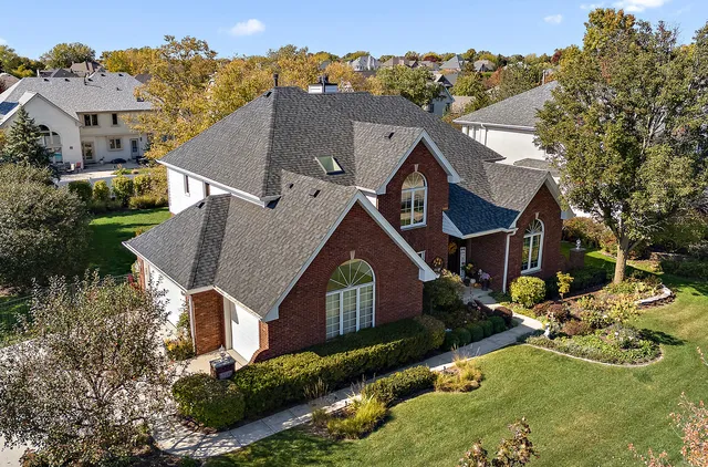 an aerial view of a house with a garden and swimming pool