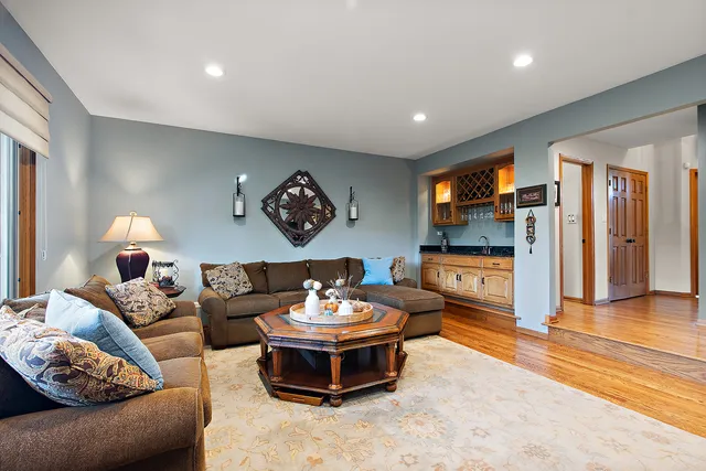 a living room with fireplace furniture and a flat screen tv