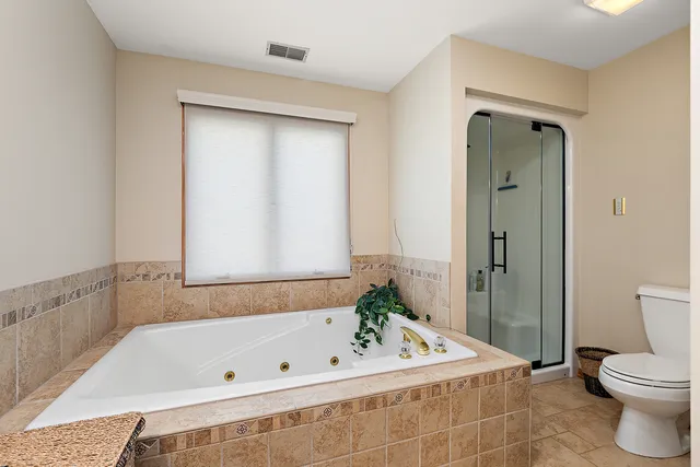 a bathroom with a granite countertop bathtub sink and mirror