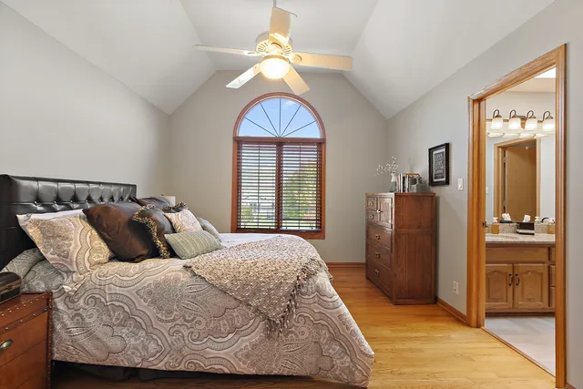 a bathroom with a granite countertop sink a light fixture and a mirror